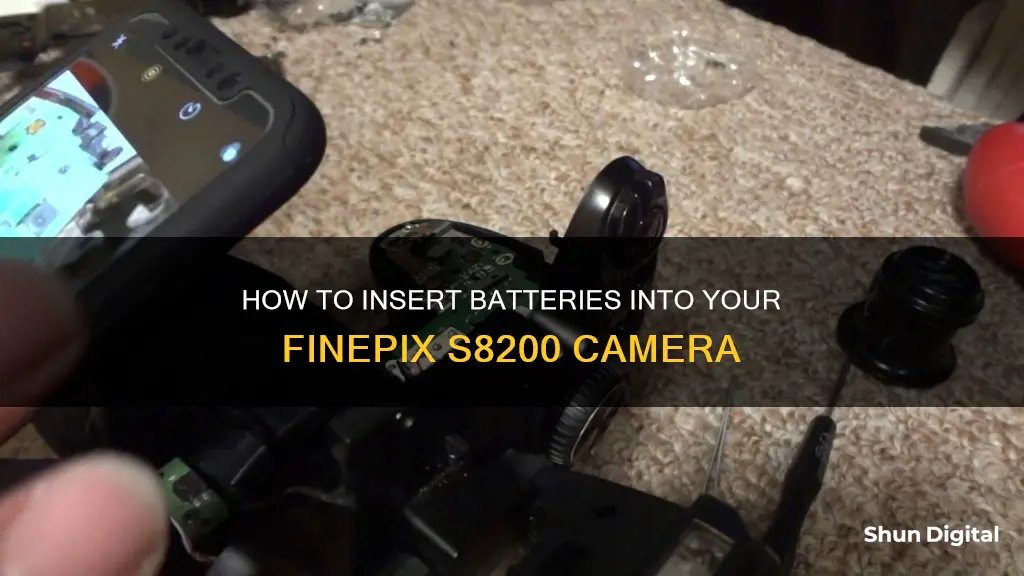 do I insert the batteries into my finepix s8200 camera